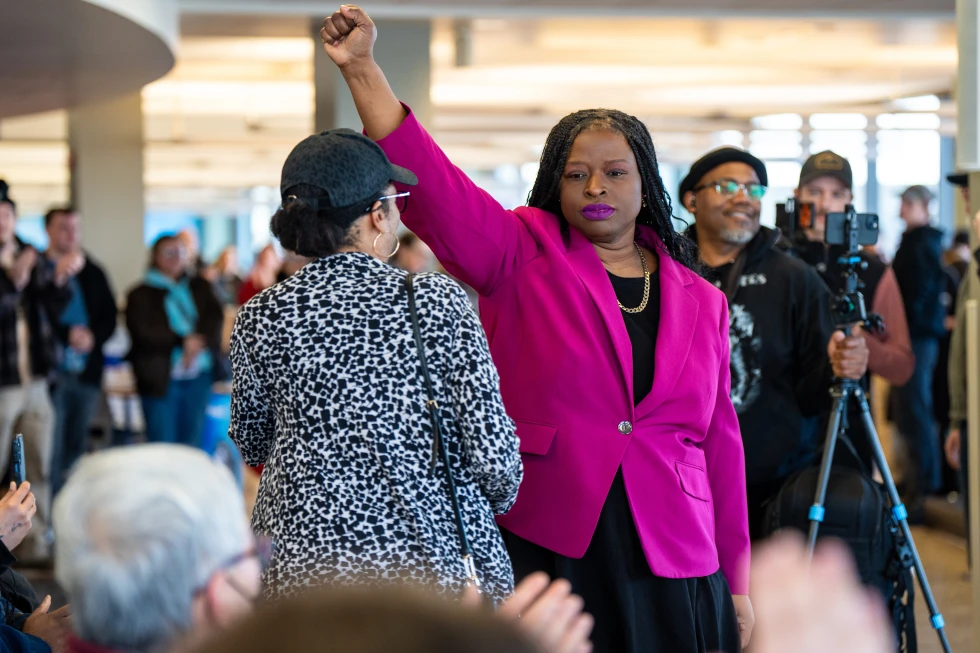 Nekima Levy Armstrong holds up her fist after speaking at an anti-ICE rally Monday in St. Paul, Minn. (Angelina Katsanis / Associated Press)