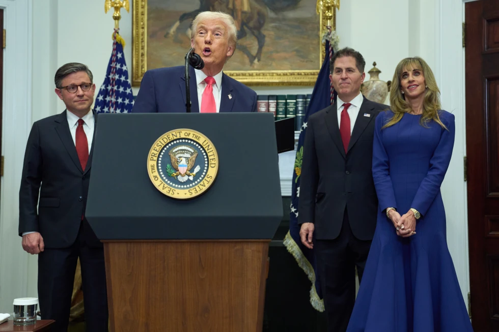 President Donald Trump speaks during an event on “Trump Accounts” for kids in the Roosevelt Room of the White House, Tuesday, Dec. 2, 2025, in Washington. From left, Speaker of the House Mike Johnson, of La., Trump, Michael Dell, and his wife Susan. (AP Photo/Evan Vucci)