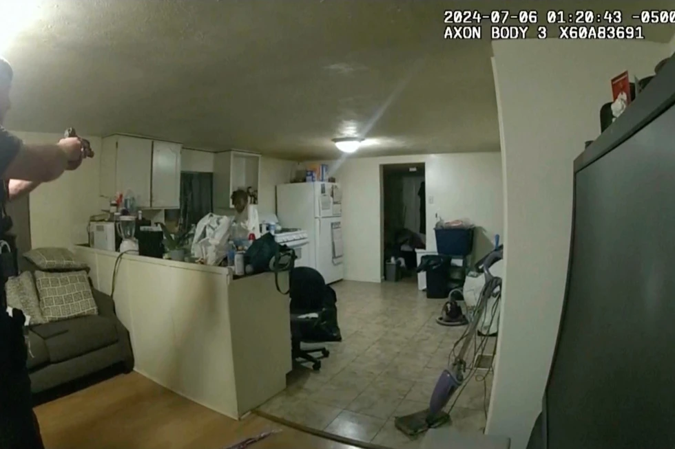 In this image taken from body camera video released by Illinois State Police on Monday, July 22, 2024, former
Sangamon County Sheriff's Deputy Sean Grayson, left, points his gun at Sonya Massey, who called 911 for help, before shooting and killing her inside her home in Springfield, IIl., July 6, 2024. (Illinois State Police via AP, File)