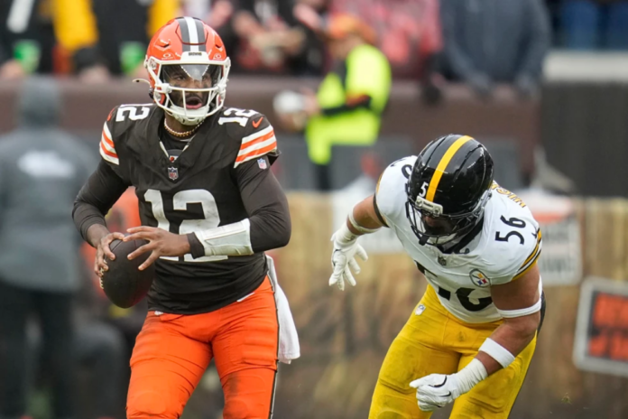 Cleveland Browns quarterback Shedeur Sanders (12) runs from Pittsburgh Steelers linebacker Alex Highsmith (56) during the second half of an NFL football game, Sunday, Dec. 28, 2025, in Cleveland. (AP Photo/Sue Ogrocki)
