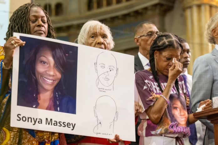 Donna Massey, center right, wipes tears from her face as she listens to Rev. Al Sharpton, right, speak during a press conference over the shooting death of her daughter, Sonya, who was killed by Illinois sheriff's deputy Sean Grayson, at New Mount Pilgrim Church in Chicago, July 30, 2024. (Tyler Pasciak LaRiviere/Chicago Sun-Times via AP, File)