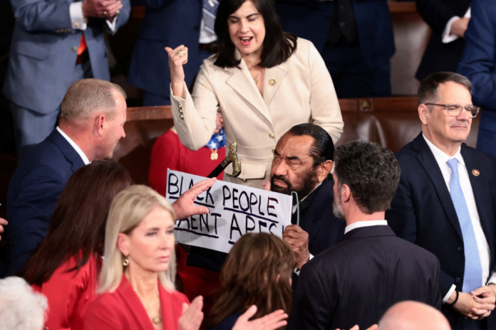 U.S. Rep. Al Green (D-TX) holds a sign as U.S. President Donald Trump delivers the State of the Union address to a joint session of Congress at the U.S. Capitol in Washington, D.C., U.S., February 24, 2026. REUTERS/Evelyn Hockstein