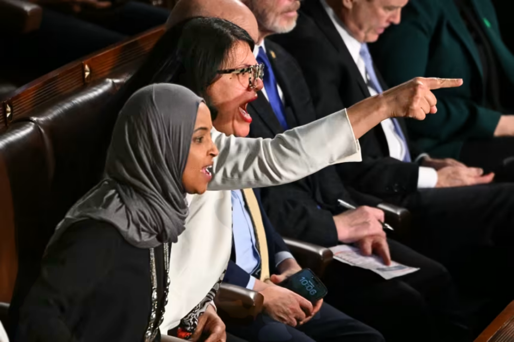 US Representatives Ilhan Omar, Democrat from Minnesota, and Rashida Tlaib, Democrat from Michigan, shout as President Donald Trump delivers the State of the Union address in the House Chamber of the US Capitol in Washington, DC, on February 24, 2026. Andrew Caballero-Reynolds/AFP/Getty Images
