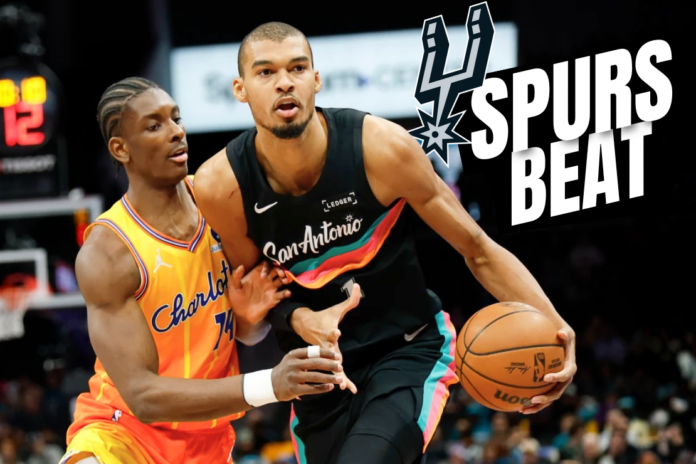 San Antonio Spurs forward Victor Wembanyama, right, moves the ball against Charlotte Hornets forward Moussa Diabate during the first half of an NBA basketball game in Charlotte, N.C., Saturday, Jan. 31, 2026. (AP Photo/Nell Redmond)