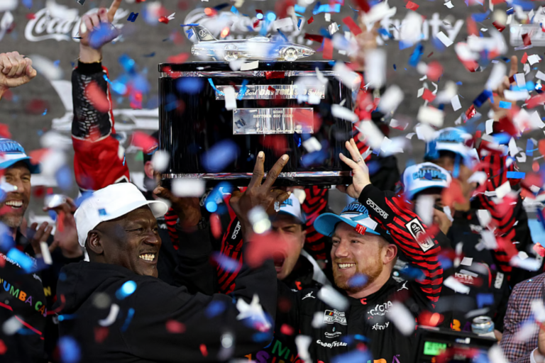 Tyler Reddick, driver of the #45 Chumba Casino Toyota, and Michael Jordan, NBA Hall of Famer and co-owner of 23XI Racing lift the Harley J. Earl Trophy in victory lane after winning the NASCAR Cup Series Daytona 500 at Daytona International Speedway on February 15, 2026 in Daytona Beach, Florida. (Photo by Chris Graythen/Getty Images)
