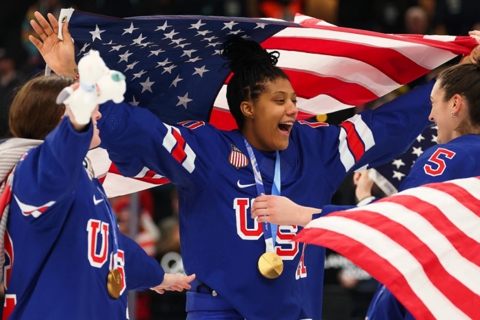 Gold medalists Laila Edwards #10 and Megan Keller #5 of Team United States celebrate after the medal ceremony for Women's Ice Hockey after the Women's Gold Medal match between the United States and Canada on day 13 of the Milano Cortina 2026 Winter Olympic games at Milano Santagiulia Ice Hockey Arena on February 19, 2026 in Milan, Italy. (Photo by Gregory Shamus/Getty Images)