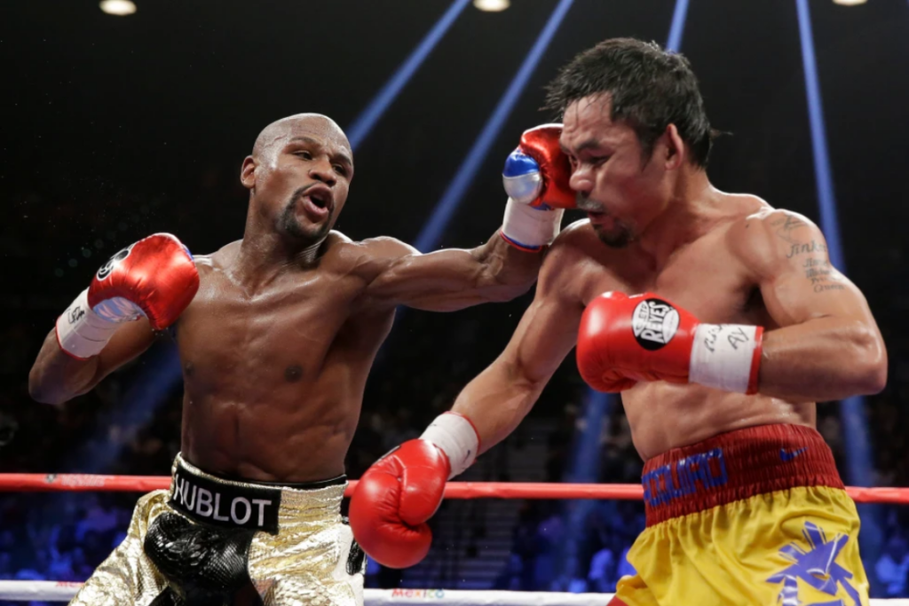 Floyd Mayweather Jr., left, hits Manny Pacquiao, from the Philippines, during their welterweight title fight on May 2, 2015, in Las Vegas. (AP Photo/Isaac Brekken, File)