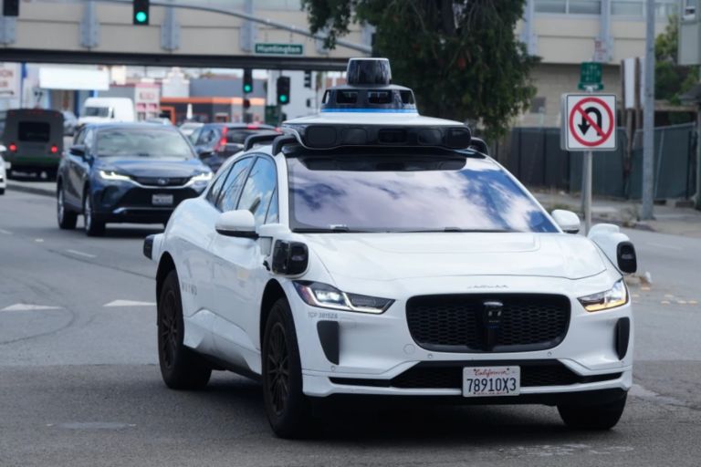 A Waymo vehicle drives past a No U-Turn sign in San Bruno, Calif., Tuesday, Sept. 30, 2025. (AP Photo/Jeff Chiu, File)