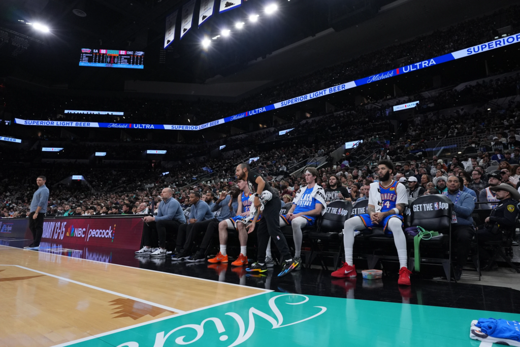 A limited roster of players watch from the bench during the second half of an NBA basketball game against the San Antonio Spurs in San Antonio, Wednesday, February. 4, 2026. (AP Photo/Eric Gay)