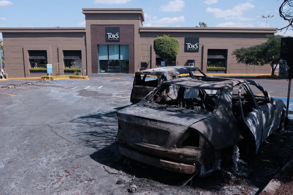 Charred vehicles sit in a parking lot sit outside a shopping mall in Guadalajara, Jalisco state, Mexico, Sunday, Feb. 22, 2026, as authorities reported that the Mexican Army killed Jalisco New Generation Cartel leader Nemesio Oseguera, known as “El Mencho.” (AP Photo/Alejandra Leyva)