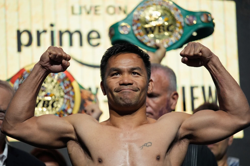 Manny Pacquiao poses on the scale during a ceremonial weigh in July 18, 2025, in Las Vegas. (AP Photo/John Locher, File)