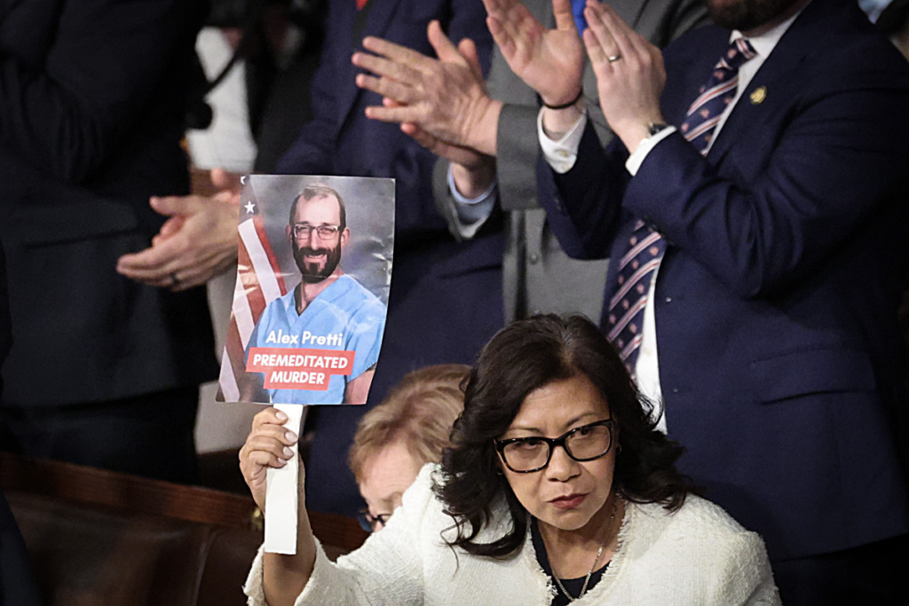 Rep. Norma Torres, D-Calif., holds up a photo of Minnesota shooting victim Alex Pretti during President Trump's State of the Union address at the U.S. Capitol on Tuesday.

Win McNamee/Getty Images