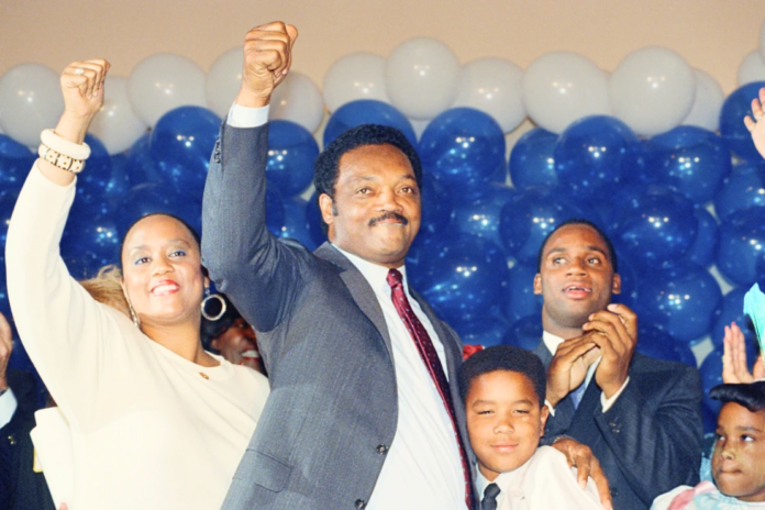 Jesse Jackson is joined by his daughter, Santita, and son Jonathan, far right, and unidentified youngster at the Los Angeles Hilton Hotel, June 8, 1988 after falling in defeat to Massachusetts Gov. Michael Dukakis in the California Democratic primary. (AP Photo/John Duricka, File)