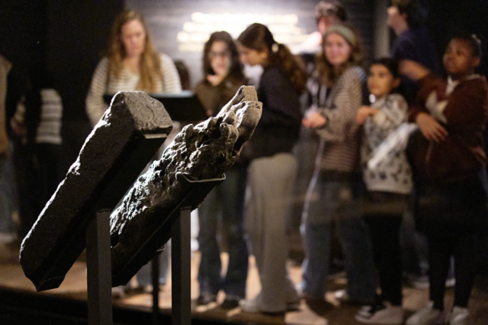 School children visit the National Museum of African American History and Culture’s Middle Passage exhibit, behind a wooden timber, the artifact at right, from the slave ship, the São José-Paquete de Africa, Friday, March 6, 2026, in Washington. (AP Photo/Jacquelyn Martin)