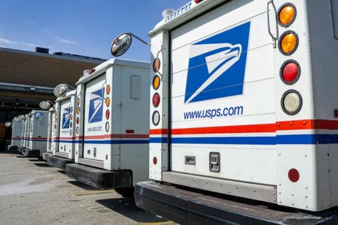 A row of USPS delivery trucks. (Photo by: Spencer Jones/GHI/UCG/Universal Images Group via Getty Images)