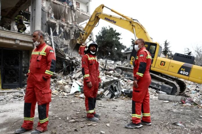 Emergency workers gather at the site of a strike on a residential building in Tehran, Iran, March 23, 2026 [Majid Asgaripour/WANA via Reuters]
