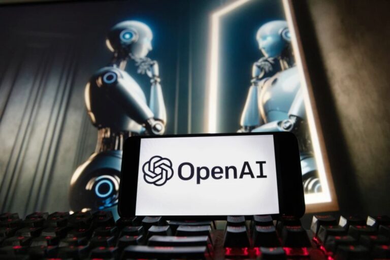 The OpenAI logo is displayed on a cellphone with an image on a computer monitor generated by ChatGPT’s Dall-E text-to-image model, Dec. 8, 2023, in Boston. (AP Photo/Michael Dwyer, File)