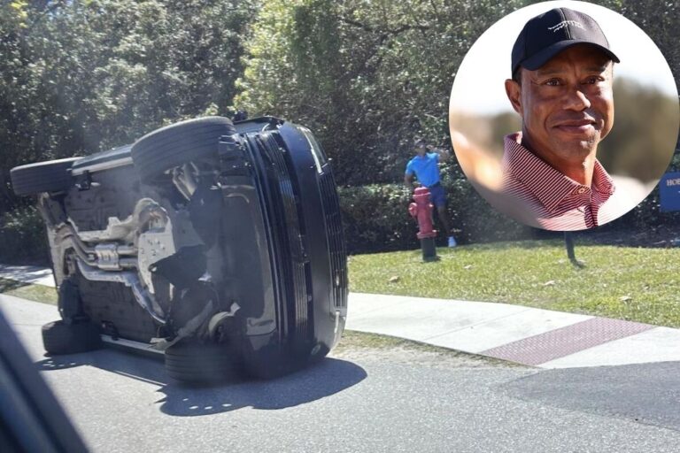 Tiger Woods stands near his overturned vehicle in Jupiter Island, Fla., on Friday. (Jason Oteri / Associated Press)