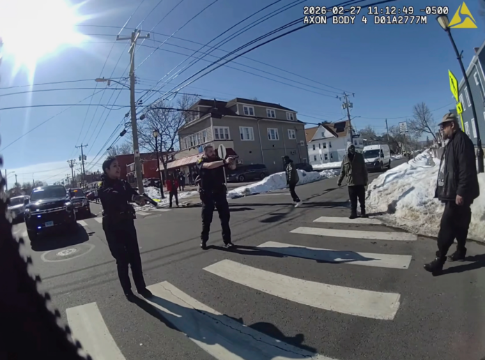 This photo taken from Hartford Police body camera video shows Steven Jones, right, as police officers shout commands to him seconds before he is shot by officer Joseph Magnano, center, Friday, Feb. 27, 2026 in Hartford, Conn. (Hartford Police Department via AP)