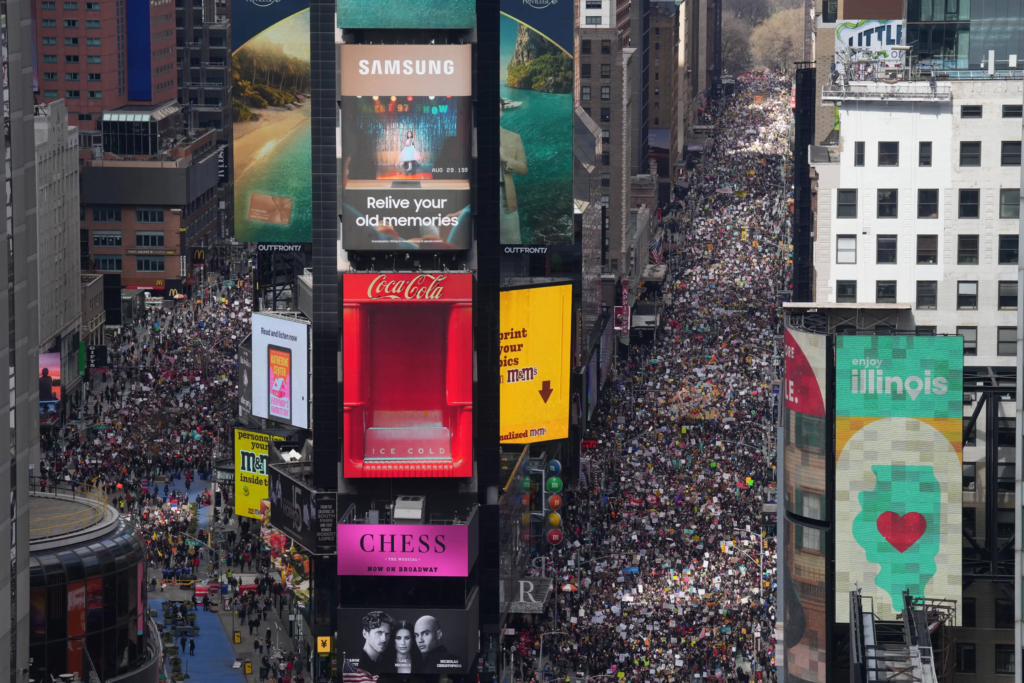 People attend a “No Kings” protest Saturday, March 28, 2026, in New York. (AP Photo/Adam Gray)