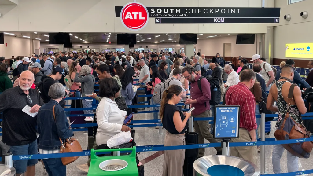 Travelers wait in line at a security checkpoint at Hartsfield-Jackson Atlanta International Airport. Photo: Courtesy of John Falchetto/AFP via Getty Images