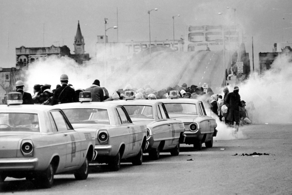 Tear gas fills the air as state troopers, ordered by Gov. George Wallace, break up a march at the Edmund Pettus Bridge in Selma, Ala., on Sunday, March 7, 1965. (AP Photo/File)