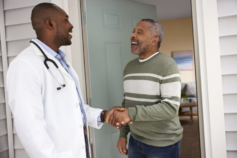 Senior patient greeting Primary Care Anywhere physician and/or nurse at front door