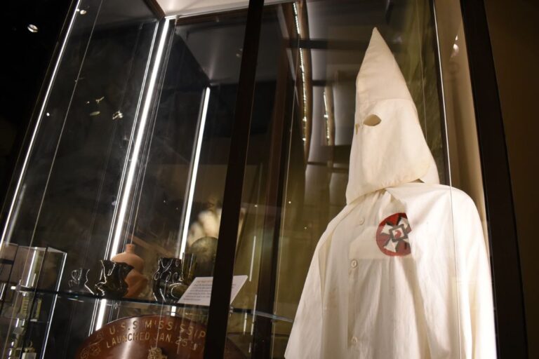 A Ku Klux Klan mask stares out over the Mississippi Museum of History on Friday, March 27, 2026, in Jackson, Miss. (AP Photo/Sophie Bates)