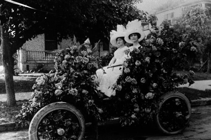 Henrietta Hummel (left) and Helen Guenther ride in a rose-covered electric car during the 1914 Battle of Flowers Parade. Courtesy of the San Antonio Light Collection, UTSA Special Collections – Institute of Texan Cultures.