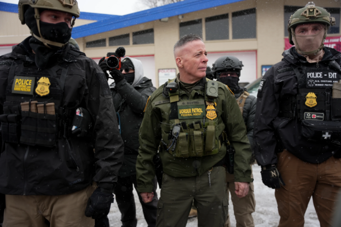 U.S. Border Patrol Cmdr. Gregory Bovino walks with Federal agents outside a convenience store Jan. 21, 2026, in Minneapolis. (AP Photo/Angelina Katsanis, File)