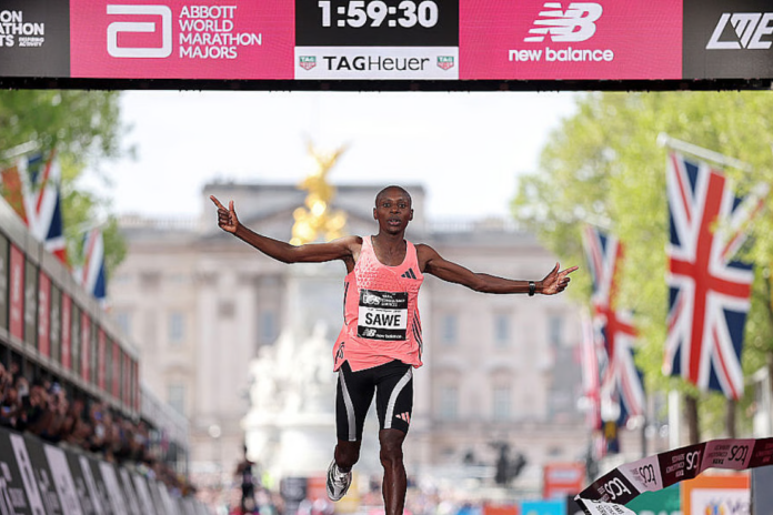 Sabastian Sawe of Team Kenya celebrates crossing the line and winning with a new world record time of 1:59:30 during the 2026 TCS London Marathon on April 26, 2026, in London, England.