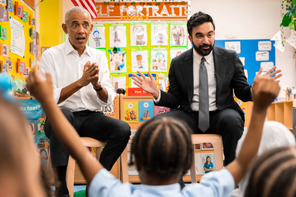 Former President Barack Obama and Mayor Zohran Mamdani sing "Wheels on the Bus" to children at Learning Through Play Pre-K in New York, Saturday, April 18, 2026. (AP Photo/Angelina Katsanis)