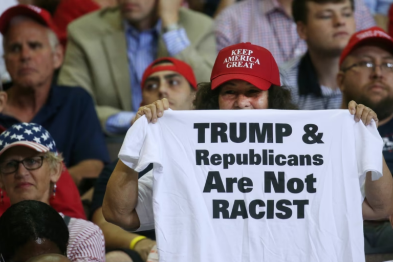 A supporter reacts by showing a T-shirt as U.S. President Donald Trump speaks during a campaign rally in Cincinnati, Aug. 1, 2019.