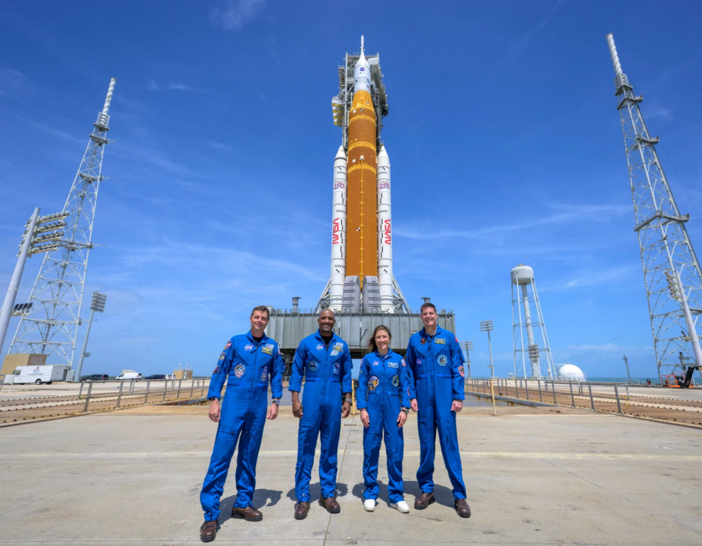 NASA astronauts Reid Wiseman, Artemis II commander, from left, Victor Glover, Artemis II pilot, Christina Koch, Artemis II mission specialist, and CSA (Canadian Space Agency) astronaut Jeremy Hansen, Artemis II mission specialist, right, in a group photograph as they visit NASA’s Artemis II SLS (Space Launch System) rocket and Orion spacecraft, Monday, March 30, 2026, at Launch Complex 39B of NASA’s Kennedy Space Center, in Cape Canaveral, Fla. (Bill Ingalls/NASA via AP)