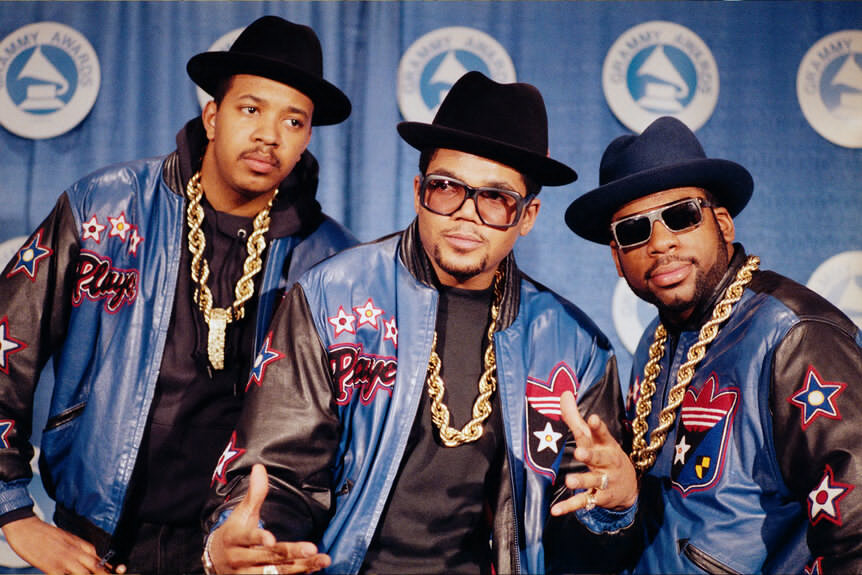 RUN-DMC poses in full regalia that they popularized- heavy gold chains, hats, sunglasses, and Adidas track suits in March of 1988 Photo: Getty Images