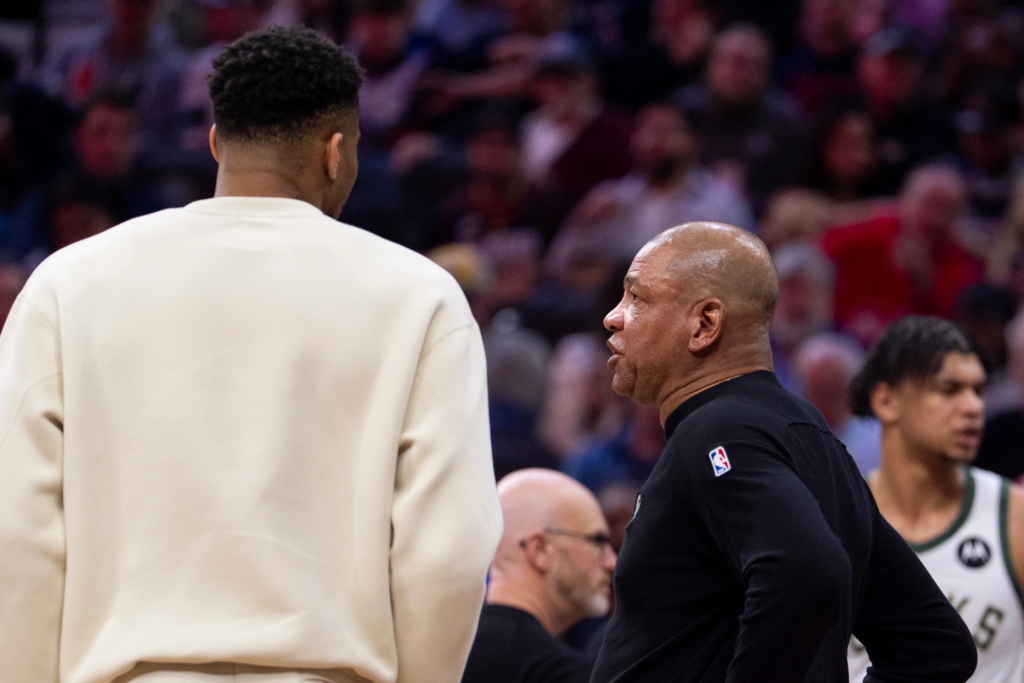 Milwaukee Bucks head coach Doc Rivers, front right, talks with power forward Giannis Antetokounmpo, left, during the first half of an NBA basketball game against the Philadelphia 76ers, Sunday, April 12, 2026, in Philadelphia.
(AP Photo/Chris Szagola)