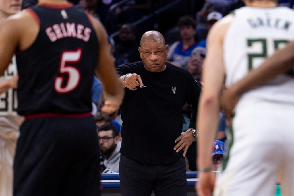 Milwaukee Bucks head coach Doc
Rivers, center, directs his team from the sideline during the first half of an NBA basketball game against the Philadelphia 76ers, Sunday, April 12, 2026, in Philadelphia. (AP Photo/Chris Szagola)