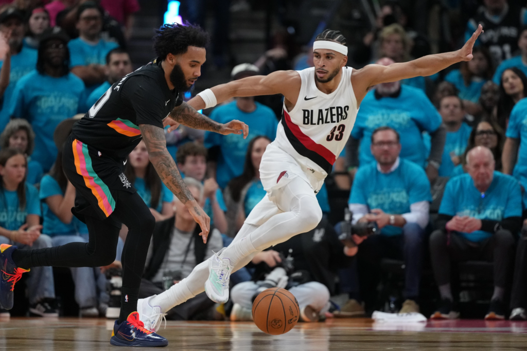 San Antonio Spurs forward Julian Champagnie (30) drives against Portland Trail Blazers forward Toumani
Camara (33) during the first half in Game 1 of a first-round NBA playoffs basketball series in San Antonio, Sunday, April 19, 2026, (AP Photo/Eric Gay)