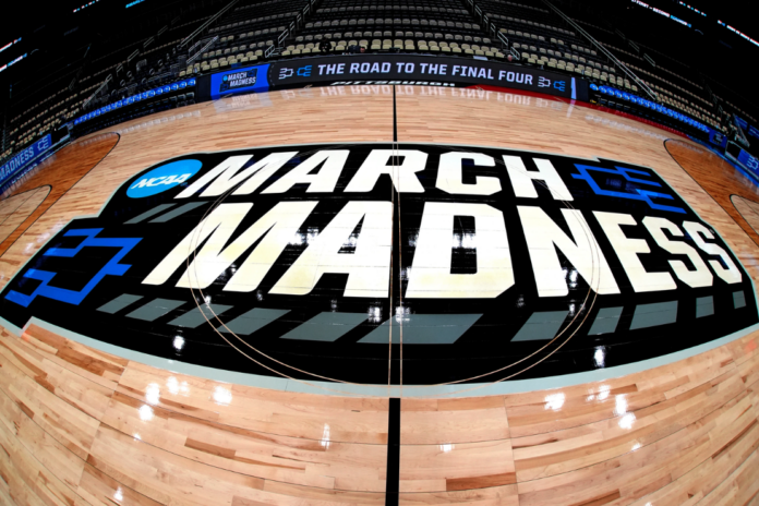 March Madness logo is displayed at center court during the opening rounds of the NCAA college basketball tournament in Pittsburgh, Wednesday, March 20, 2024. (AP Photo/Gene J.Puskar, File)
