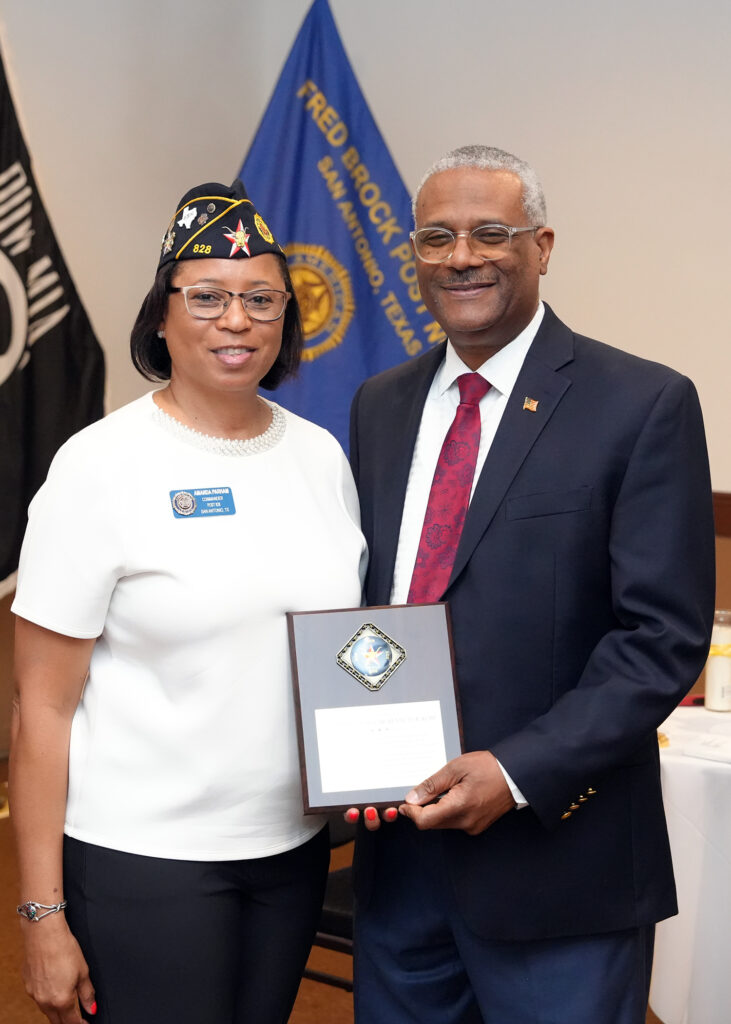 Post Commander Amanda Parham presents a plaque of appreciation to retired U.S. Army Col. Rev. Dr. Kenneth R. Kemp, pastor of Antioch Missionary Baptist Church, for serving as the keynote speaker during a Memorial Day Ceremony held at Fred Brock American Legion Post No. 828. (Photo by Legionnaire Burrell Parmer/TEXALPA)