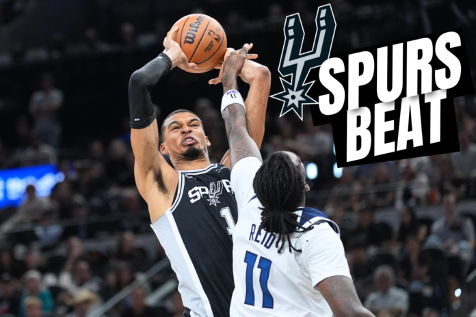 San Antonio Spurs forward Victor Wembanyama (1) grabs a rebound over Minnesota Timberwolves center Naz Reid (11) during the first half of Game 5 of an NBA basketball second-round playoffs series in Minneapolis, Tuesday, May 12, 2026. (AP Photo/Eric Gay)
