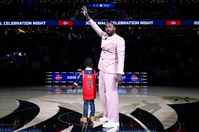 Retired NBA player John Wall stands with his sons Ace and Amir as he is honored during halftime of the game between the Washington Wizards and the Milwaukee Bucks at Capital One Arena on January 29, 2026 in Washington, DC. NOTE TO USER: User expressly acknowledges and agrees that, by downloading and or using this photograph, User is consenting to the terms and conditions of the Getty Images License Agreement. (Photo by Scott Taetsch/Getty Images)