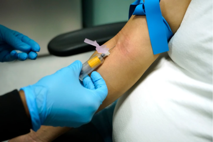 A technician draws blood at a women’s clinic in Jackson, Miss., on Dec. 17, 2021. (AP Photo/Rogelio V. Solis, File)