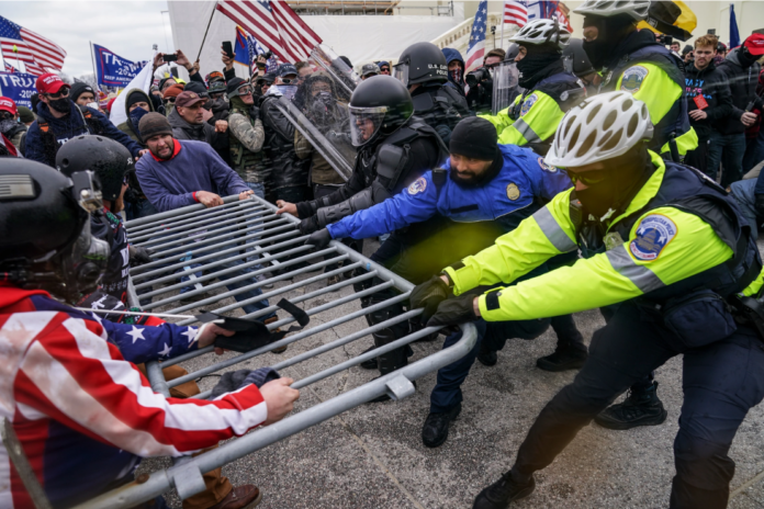 Trump supporters try to break through a police barrier, Jan. 6, 2021, at the Capitol in Washington. (AP Photo/John Minchillo, File)