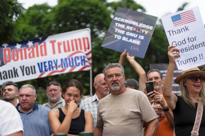White South Africans demonstrate in support of U.S. President Donald Trump in front of the U.S. embassy in Pretoria, South Africa, Feb. 15, 2025. (AP Photo/Jerome Delay, File)