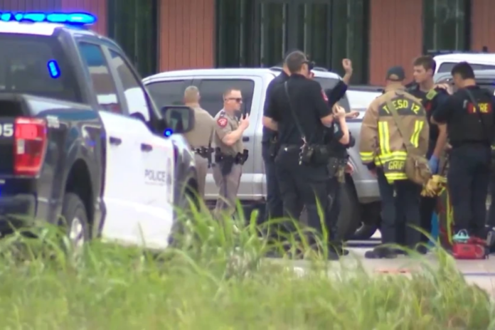 In this image taken from video provided by KVUE, emergency cervices work on a site of a shooting in Austin, Texas, Sunday, May 17, 2026. (KVUE via AP)
