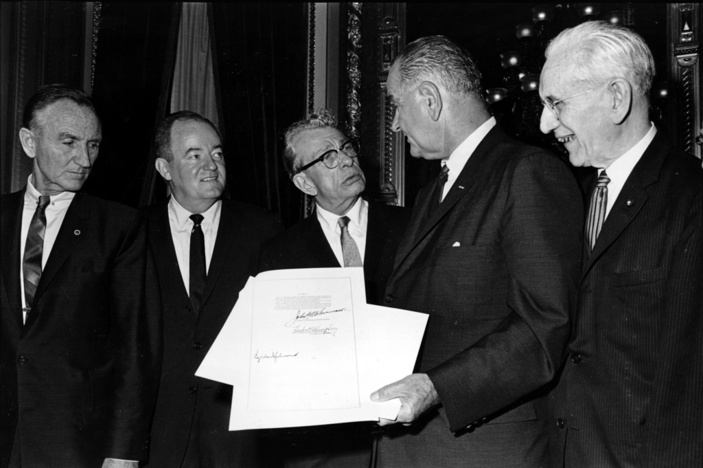President Lyndon B. Johnson holds the signed document of the Voting Rights Act of 1965 as he chats with Sen. Everett Dirksen, R-Ill., in the President’s Room in Washington, Aug. 6, 1965. Signatures that appear on the document are Johnson, left bottom; House Speaker John McCormack, upper, standing at right; and Vice President Hubert Humphrey, lower, standing second from left. Standing at far left is Sen. Mike Mansfield. (AP Photo)