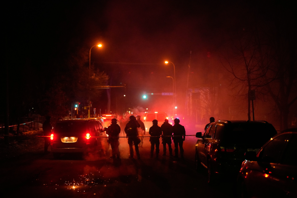 Federal immigration officers at the scene of a reported shooting Wednesday, Jan. 14, 2026, in Minneapolis. (AP Photo/John Locher, File)