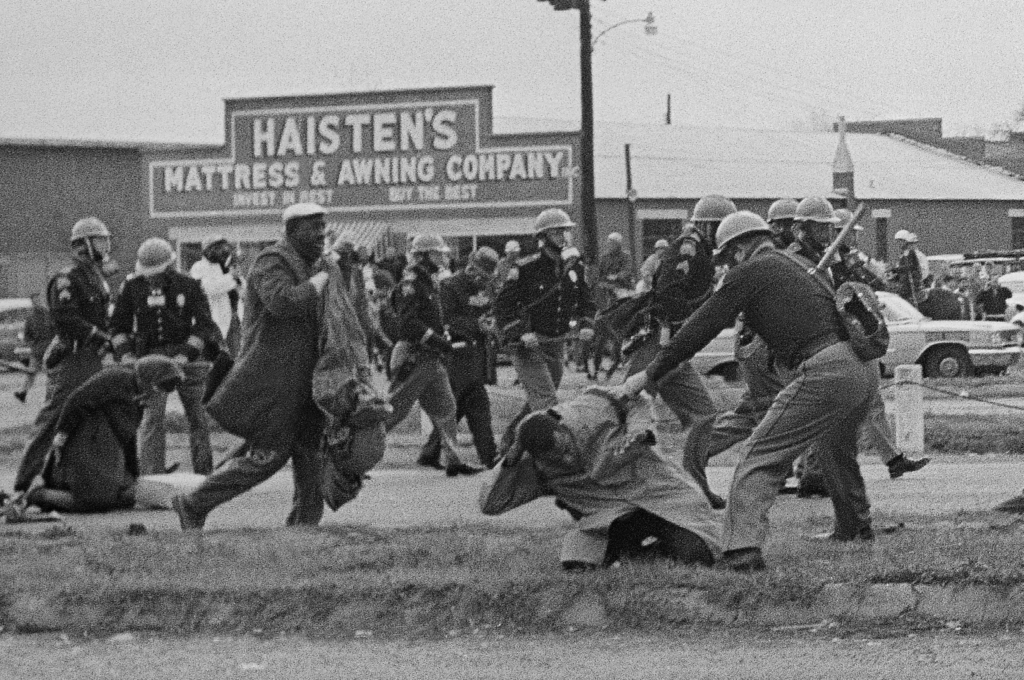 John Lewis (foreground) is beaten by a state trooper in Selma, Alabama, on March 7, 1965. The future congressman suffered a fractured skull. | AP Photo