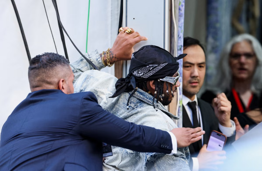 Chris Smalls is detained after trying to enter the venue with a protest sign during the Met Gala, an annual fundraising gala held for the benefit of the Metropolitan Museum of Art's Costume Institute with this year's theme 'Costume Art' in New York City, New York, U.S., May 4, 2026. REUTERS/Brendan Mcdermid
